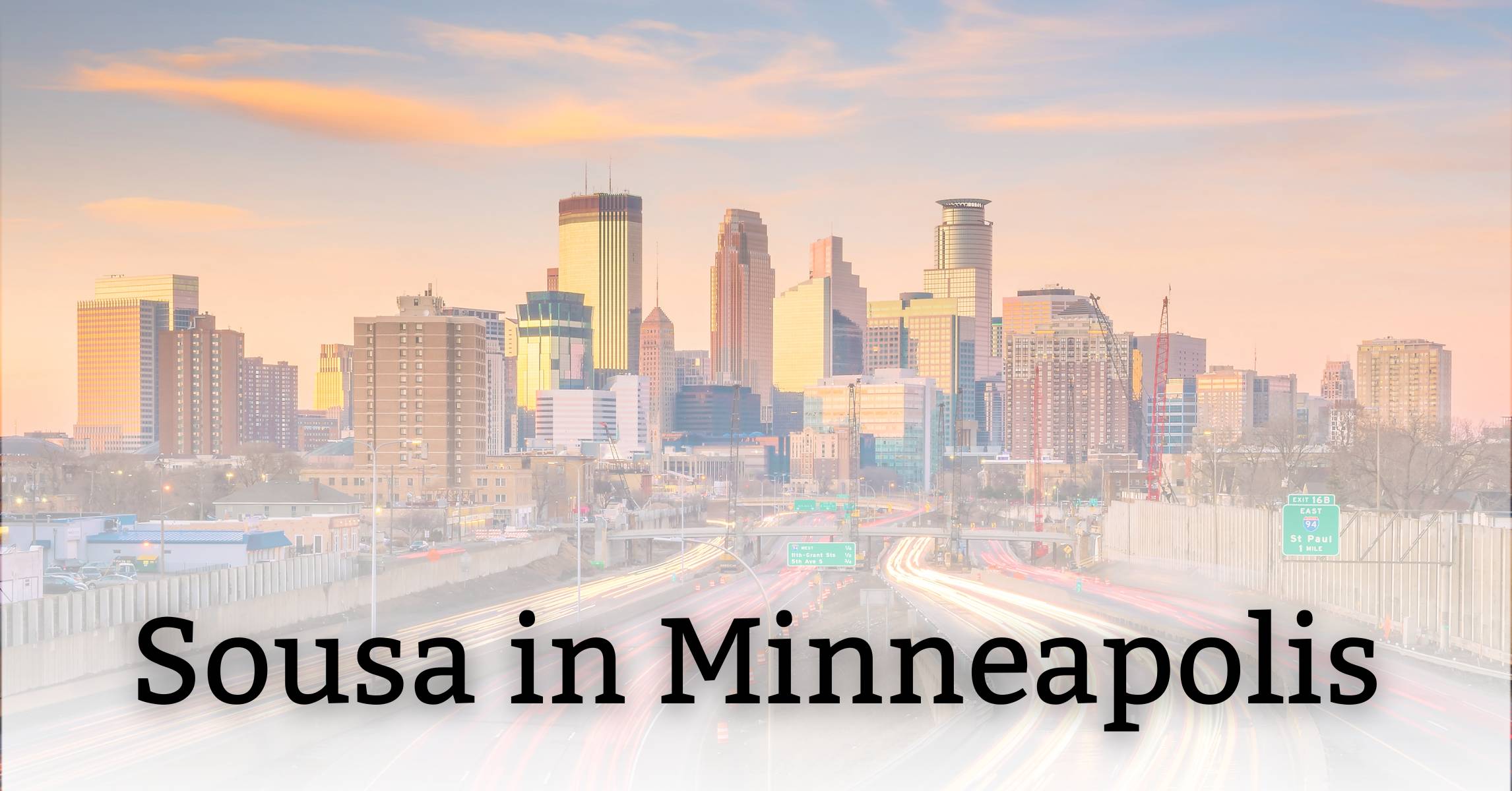 Cityscape of Minneapolis skyline at sunset or sunrise with highway in foreground and text overlay reading 
