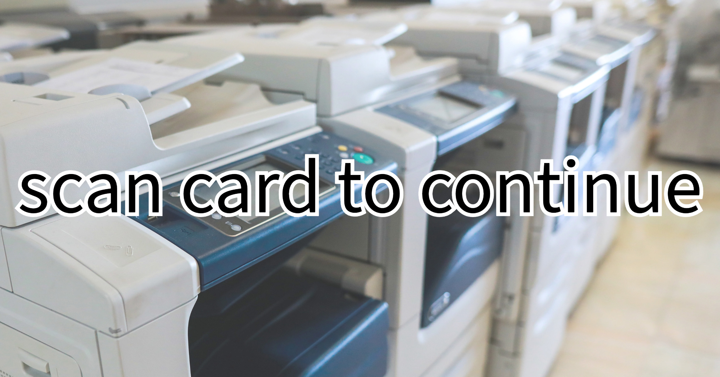 Close-up of office multifunction printers/copiers with a message overlay that reads: scan card to continue